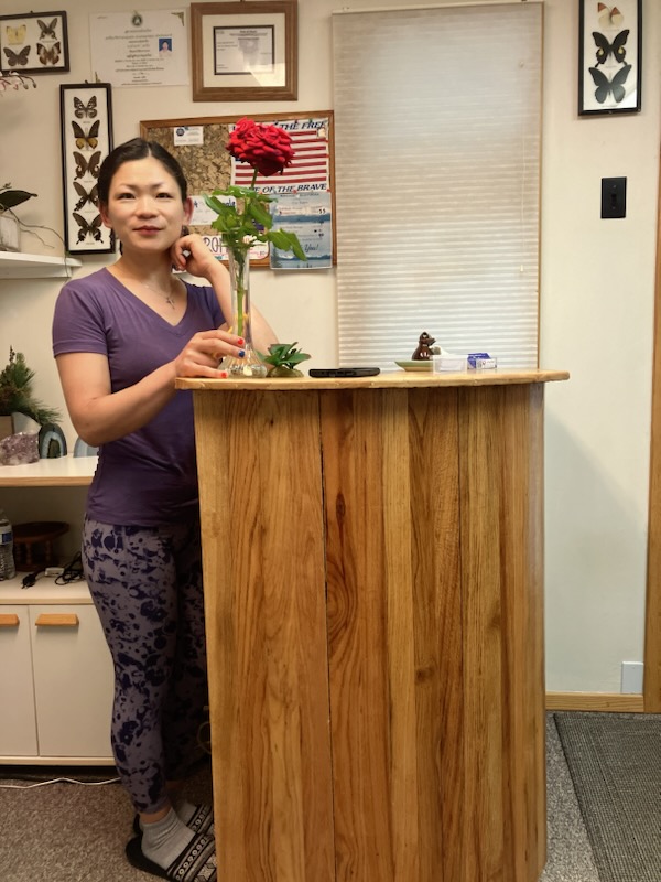 Licensed massage therapist Char standing in lobby.